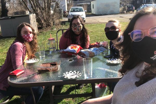 Members of an undergraduate mentoring group meeting masked and outdoors