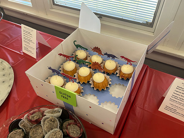 dinosaur cupcakes in a box on the table