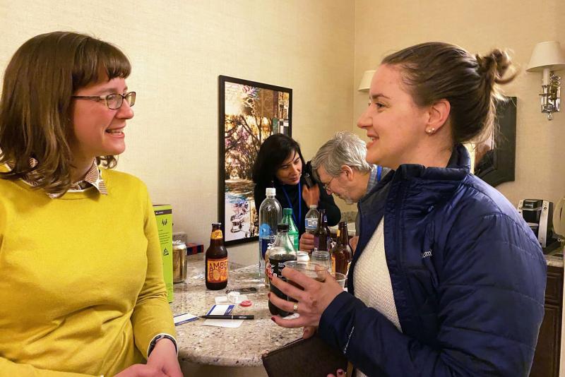 Faculty member Andrea Sims talks with Jane Mitsch (PhD '16)