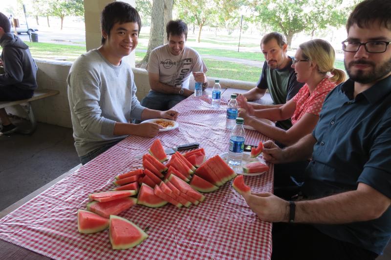 New Grad students Lifeng Jin, Jordan Needle, Noah Diewald and David King enjoy watermelon