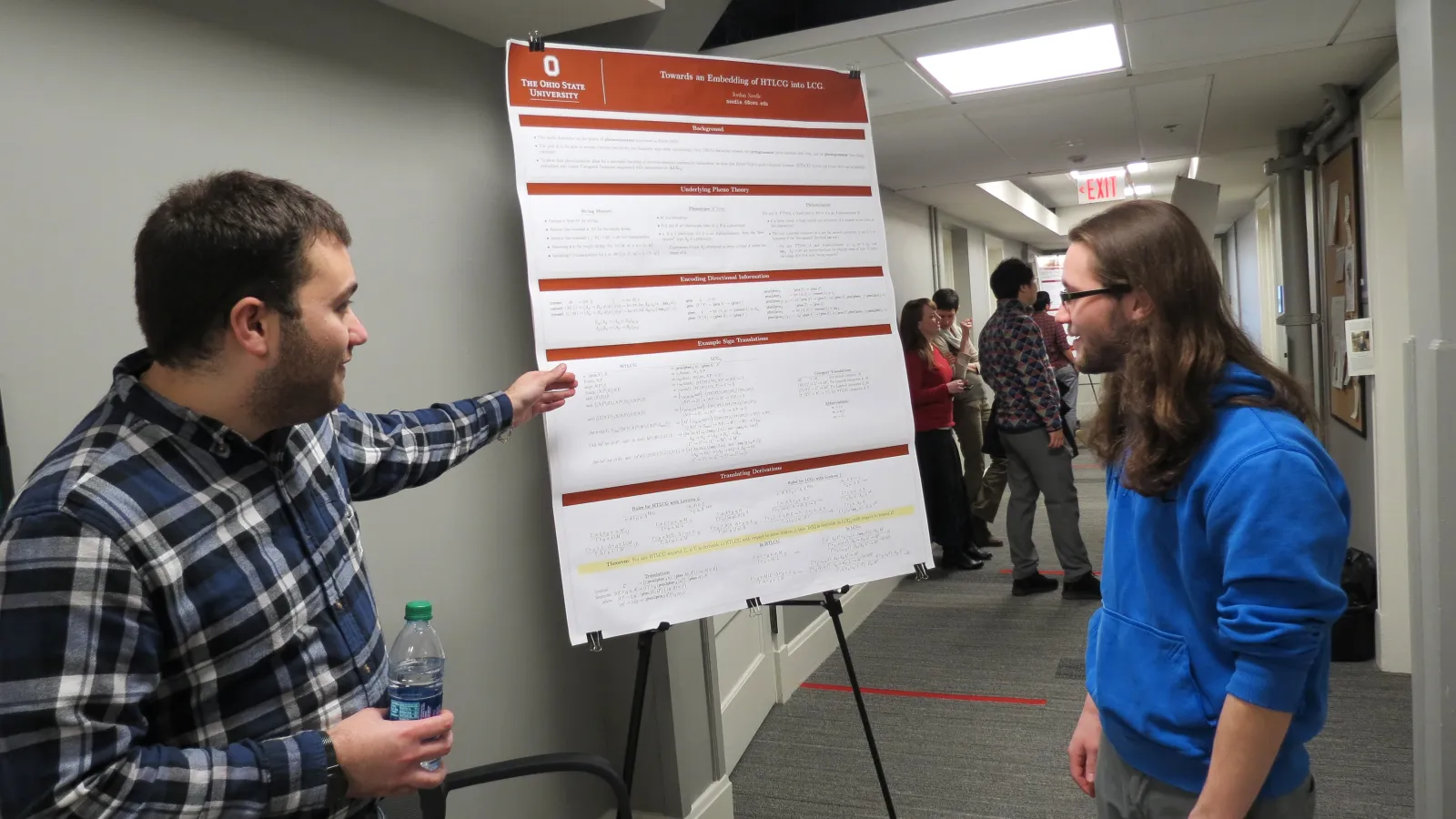 Graduate student Jordan Needle presenting a poster