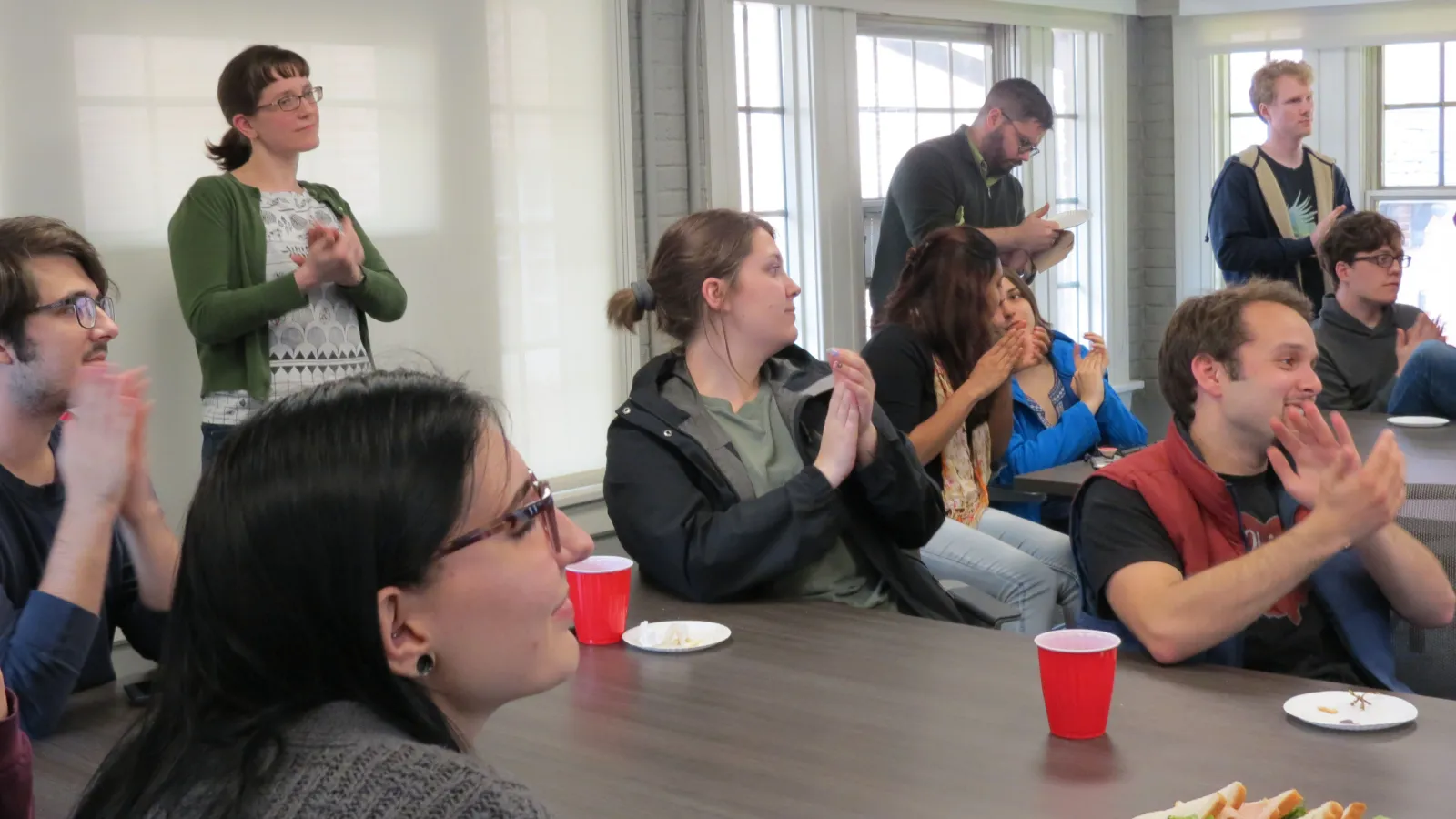 Linguistics faculty and students applauding at the 2019 end-of-year reception