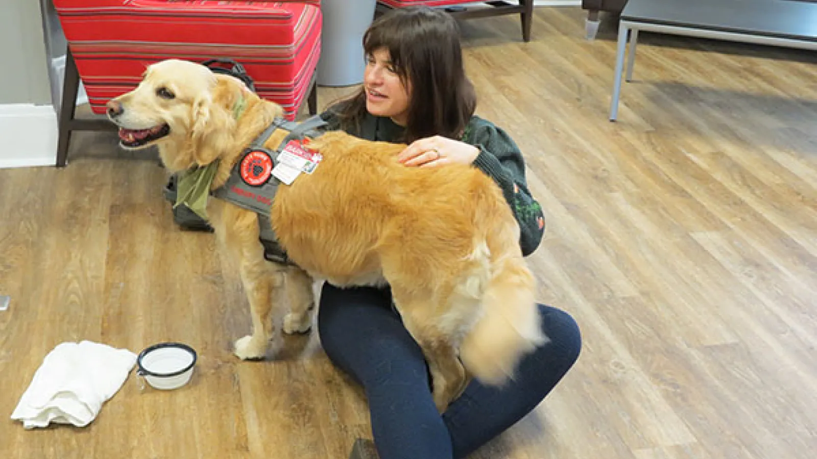 Dr. Kantarovich sits with the dog Mabel from Buckeye Paws