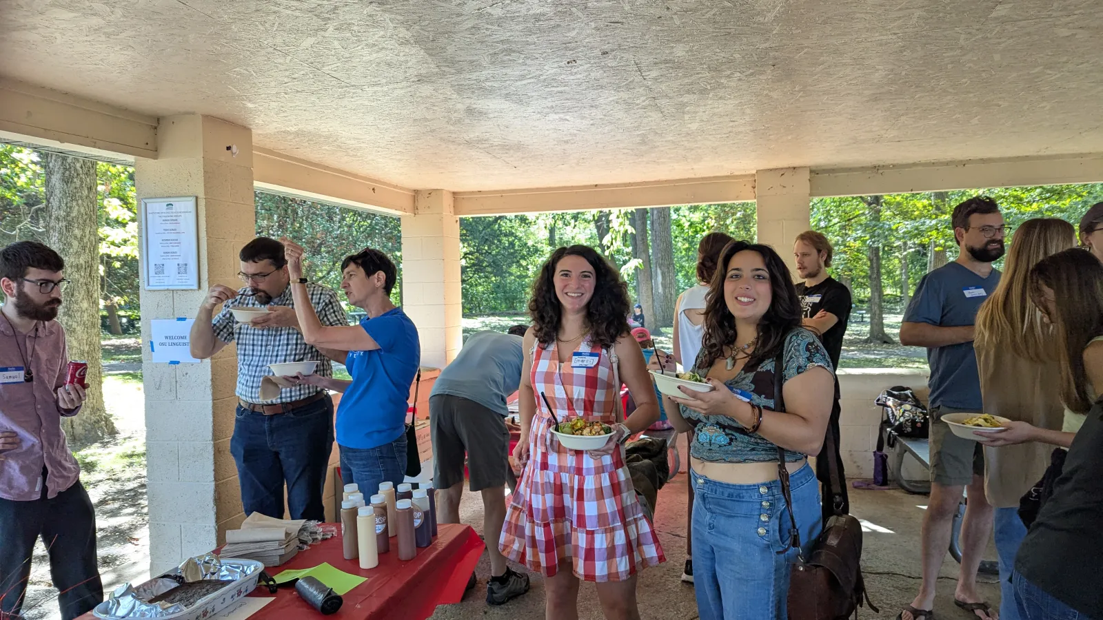 many people under a pavilion eating and visiting