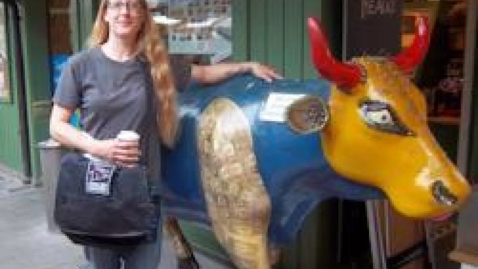 Bridget Smith standing next to a cow statue