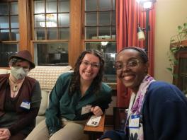faculty and students sitting on a couch, posing for the picture