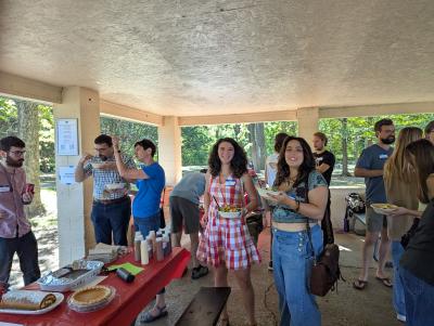 many people under a pavilion eating and visiting