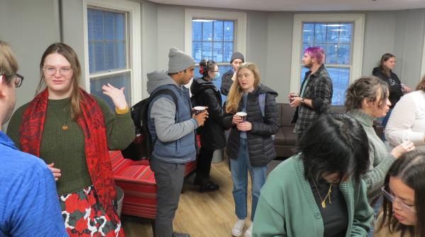 Students, faculty and staff have cocoa at the winter reception