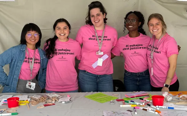Students with supplies for language activities at a community event
