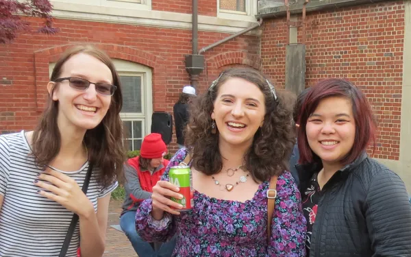 Students smiling outdoors at a departmental party