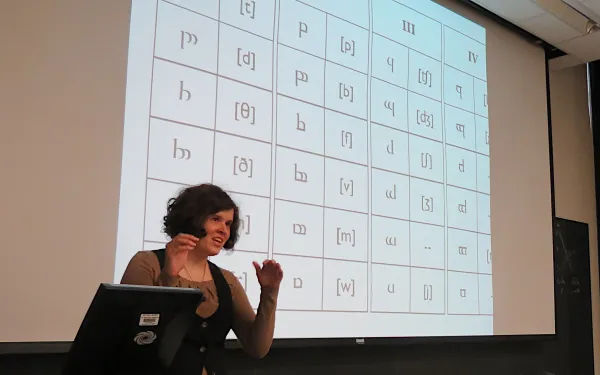 Speaker giving a talk in a lecture hall