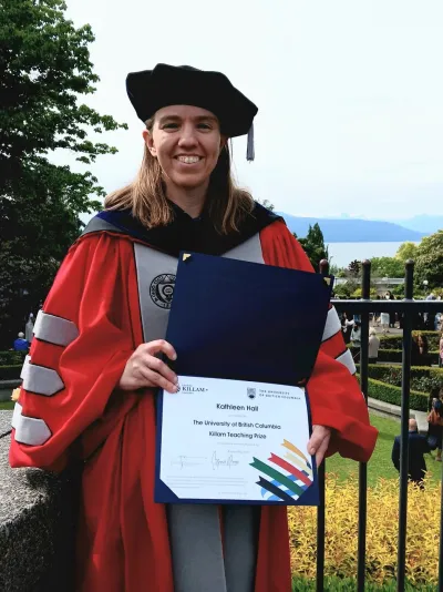 Kathleen Currie Hall holding the Killam award that she won