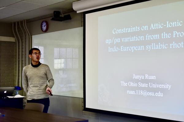 Junyu Ruan presenting a paper at a workshop.