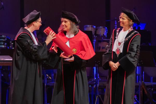 Mary Beckman accepting her honorary doctorate from Radboud University