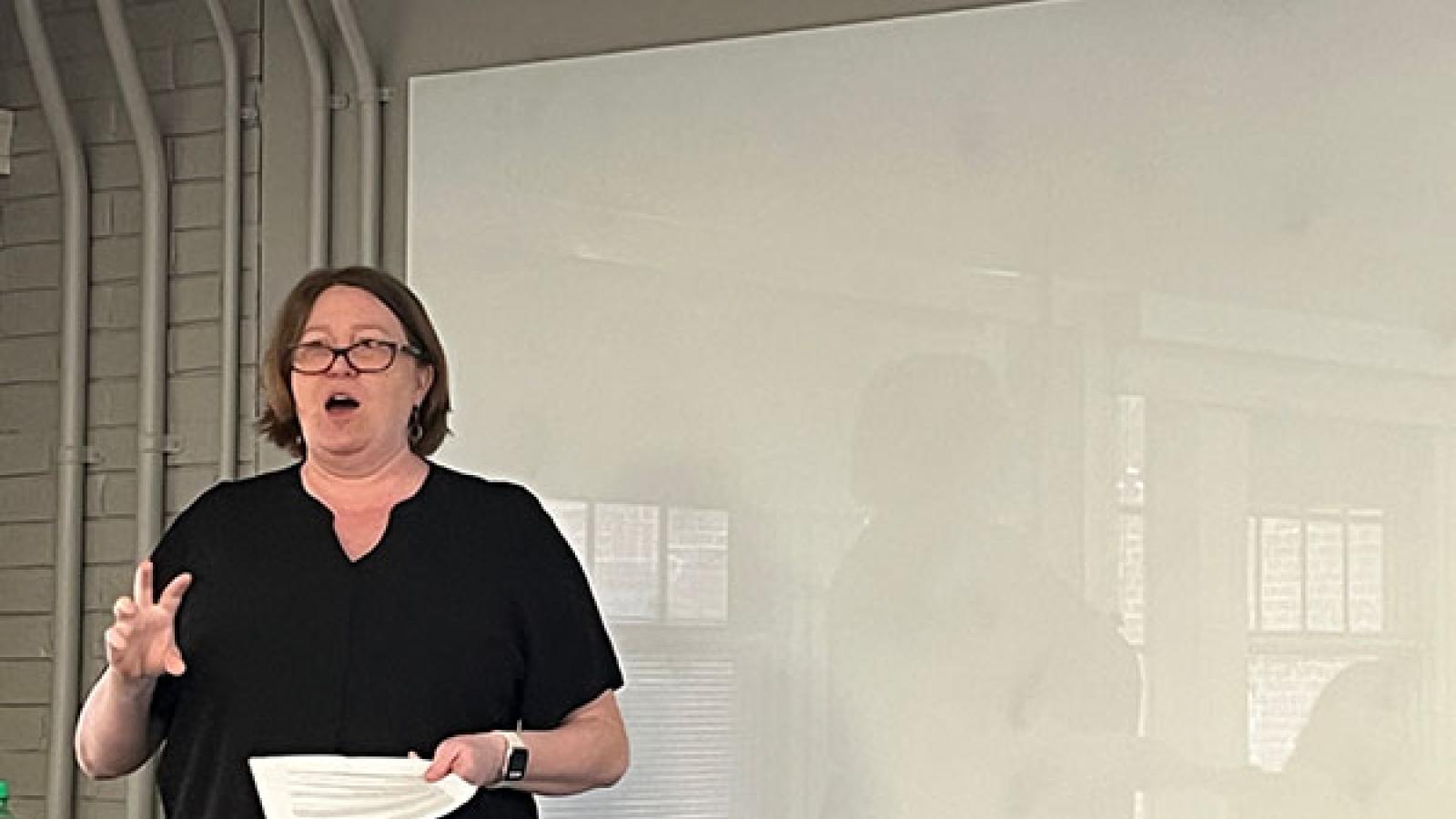 Ann Bunger is giving the pedagogy lecture, standing in front of a whiteboard