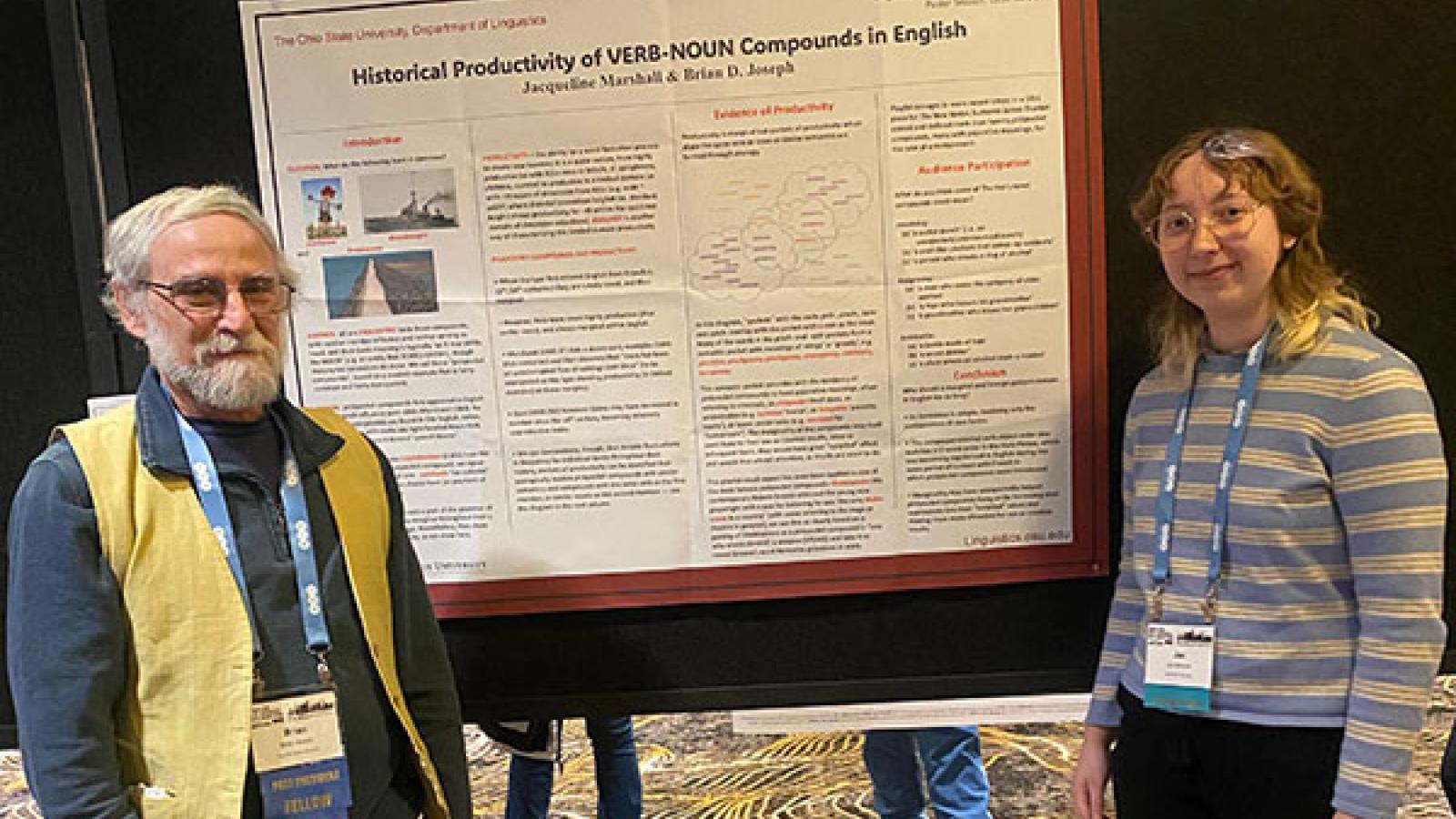 Professor Brian Joseph and student Jac Marshall stand in front of Jac's poster presentation at the LSA