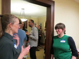 various faculty standing around and visiting