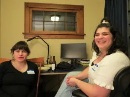 graduate student and faculty sitting on a chair and on the couch
